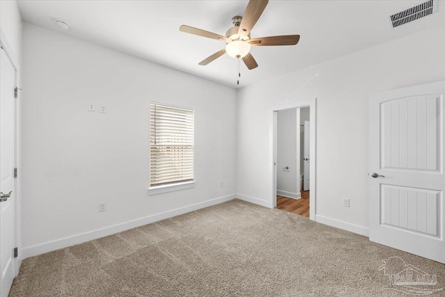 unfurnished bedroom with light carpet and ceiling fan