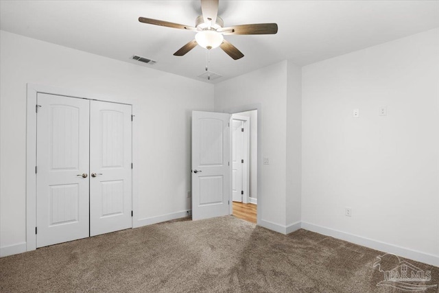 unfurnished bedroom featuring ceiling fan, carpet floors, and a closet