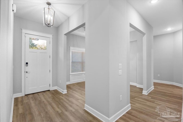 foyer with a chandelier and light hardwood / wood-style floors