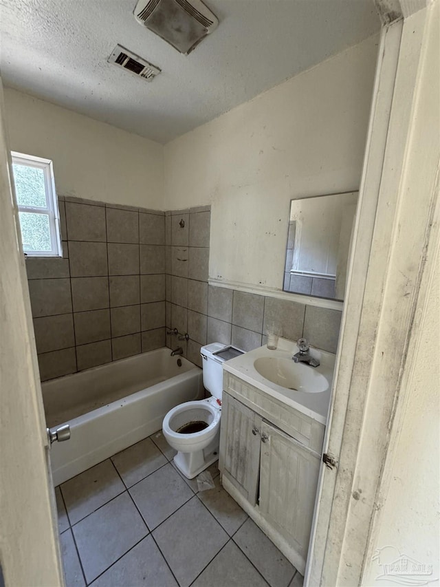 5233 Admiral Halsey Rd, Milton, FL 32583 - full bath featuring tile patterned floors, vanity, toilet, a textured ceiling, and tile walls