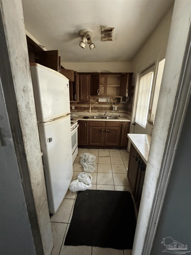 5233 Admiral Halsey Rd, Milton, FL 32583 - kitchen featuring white appliances, light tile patterned floors, light countertops, open shelves, and a sink