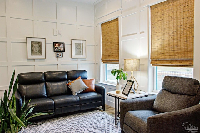 living room featuring a decorative wall and wood finished floors