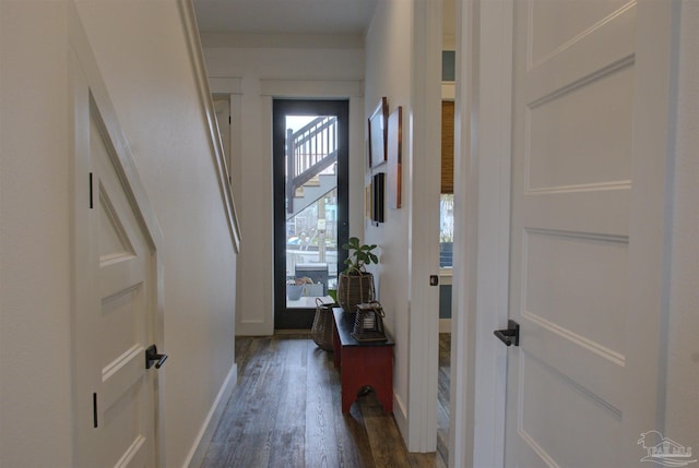 foyer with dark wood-style floors and baseboards