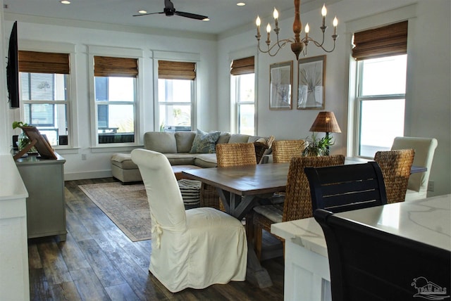 dining room with ceiling fan with notable chandelier, dark wood-type flooring, a wealth of natural light, and recessed lighting