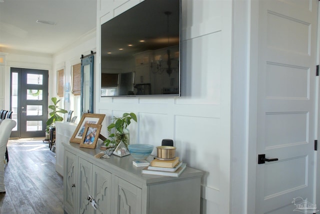 interior space with a barn door and wood finished floors