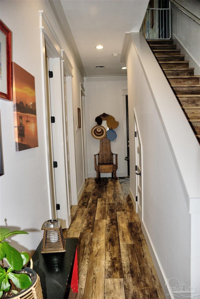 hall featuring visible vents, stairway, wood finished floors, and recessed lighting