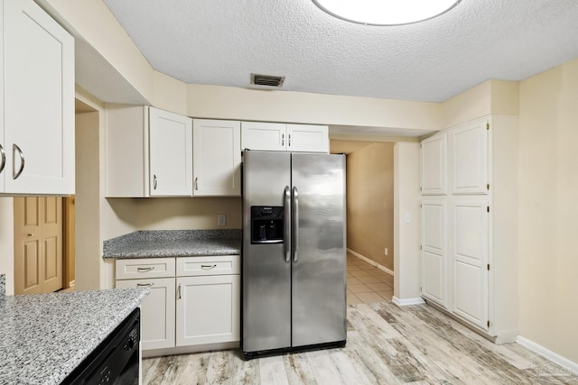 kitchen featuring white cabinets, light hardwood / wood-style flooring, a textured ceiling, and stainless steel fridge with ice dispenser