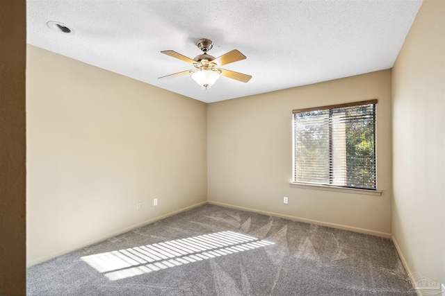 spare room with ceiling fan, a textured ceiling, and carpet floors