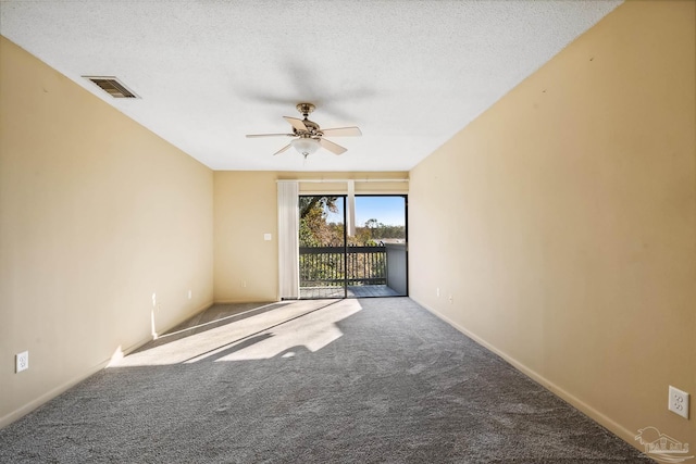 carpeted spare room with ceiling fan and a textured ceiling