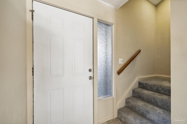 view of carpeted foyer