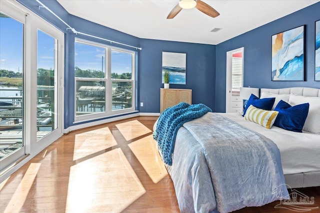 1280 Mahogany Mill Rd, Pensacola, FL 32507 - bedroom with wood finished floors, ceiling fan, baseboards, and access to outside