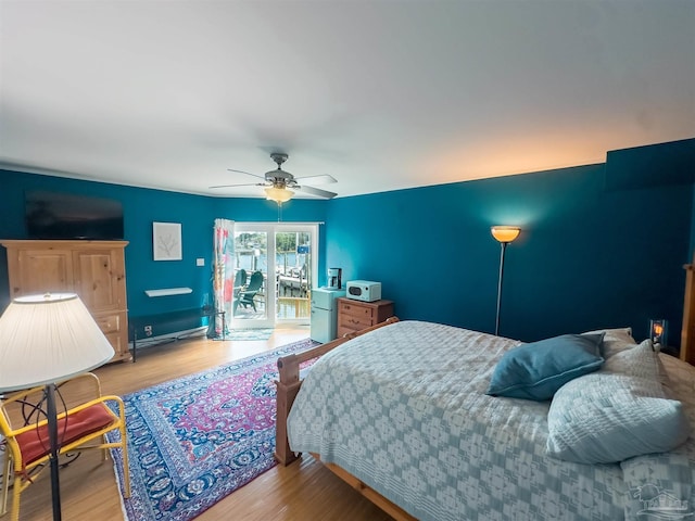 bedroom with ceiling fan, light hardwood / wood-style flooring, and access to exterior