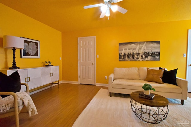 living room with wood-type flooring and ceiling fan