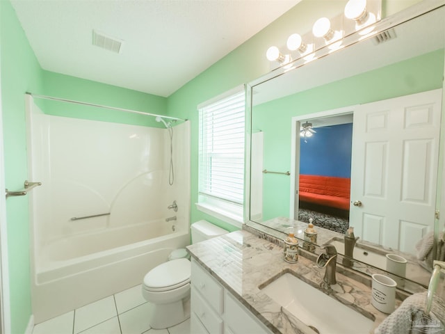 full bathroom featuring ceiling fan, toilet, vanity, tile patterned floors, and shower / bath combination