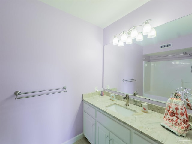 bathroom featuring vanity and a shower