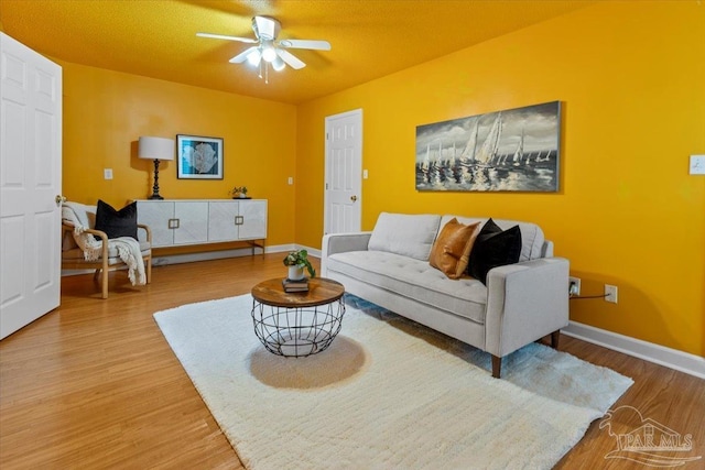 living room featuring hardwood / wood-style flooring and ceiling fan