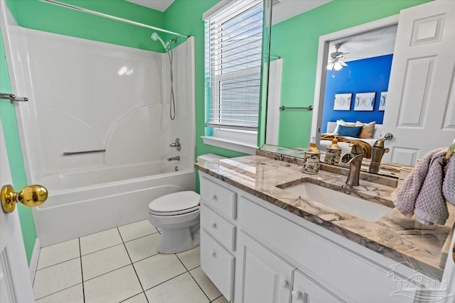 full bathroom with ceiling fan, toilet, shower / bath combination, vanity, and tile patterned flooring