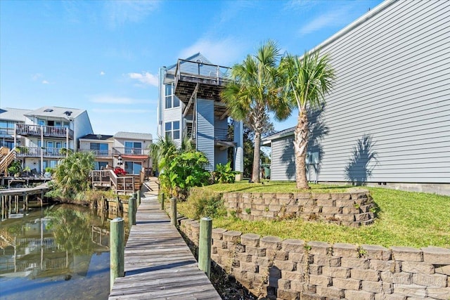 exterior space with a dock and a water view