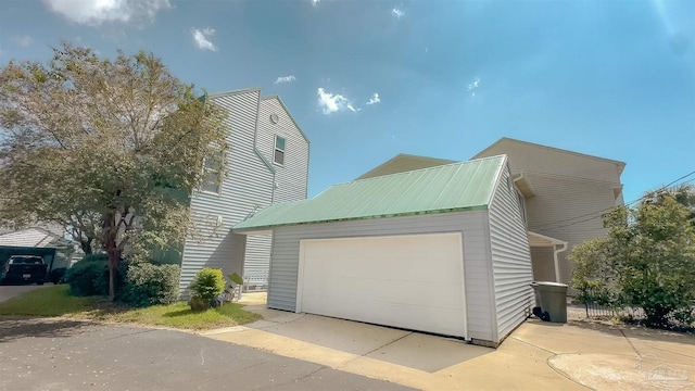 view of front of property with an outdoor structure and a garage