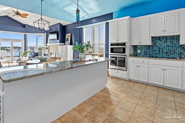 1280 Mahogany Mill Rd, Pensacola, FL 32507 - bedroom with access to outside, baseboards, wood finished floors, and a textured ceiling