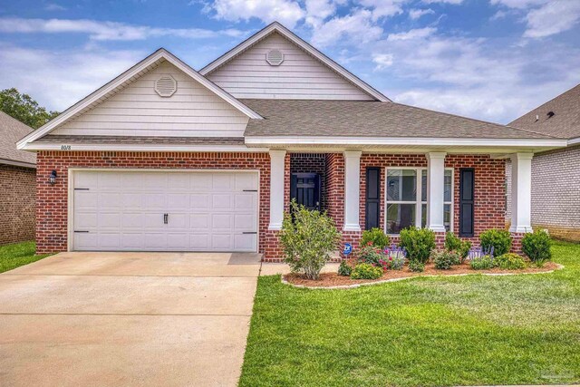 8018 Burnside Loop, Pensacola, FL 32526 - view of front of home with brick siding, a front yard, driveway, and a garage