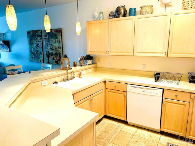 kitchen with dishwasher, light brown cabinetry, a peninsula, and a sink