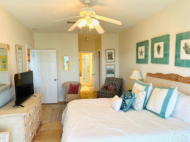 bedroom with ceiling fan and light tile patterned flooring