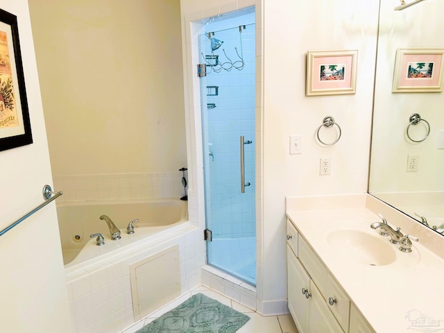 bathroom featuring a stall shower, tile patterned flooring, vanity, and a whirlpool tub