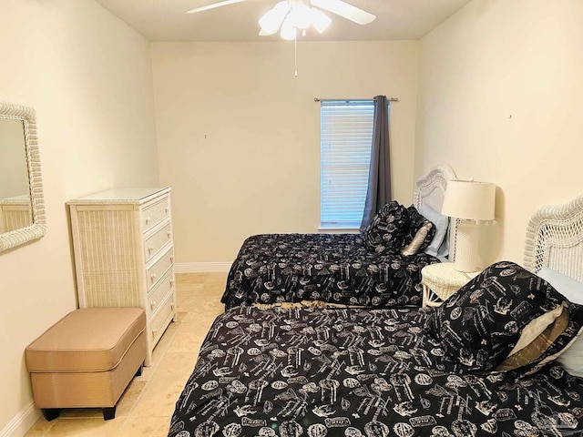 bedroom featuring ceiling fan, baseboards, and light tile patterned flooring