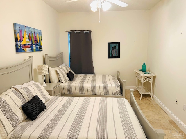 bedroom featuring ceiling fan and baseboards