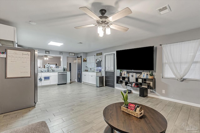 living room featuring sink and ceiling fan