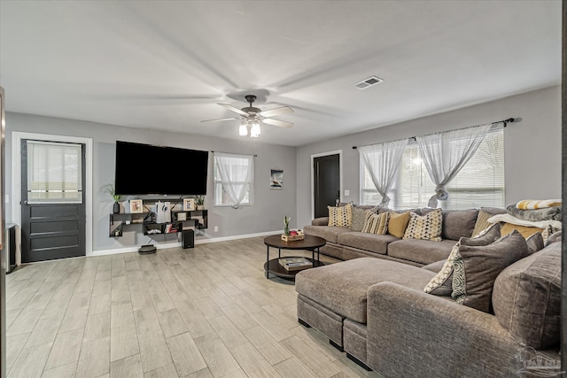 living room featuring ceiling fan and light hardwood / wood-style flooring