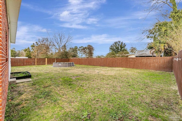 view of yard with a fenced in pool