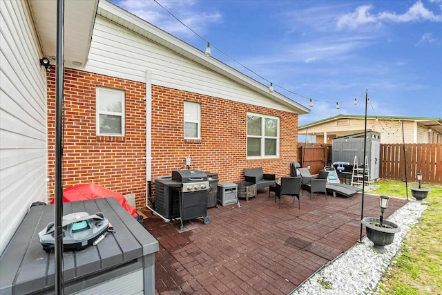 view of patio featuring area for grilling and a storage shed