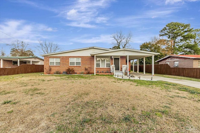 ranch-style house with a carport and a front yard