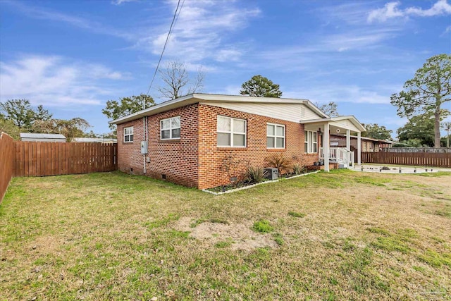 view of side of home featuring a yard