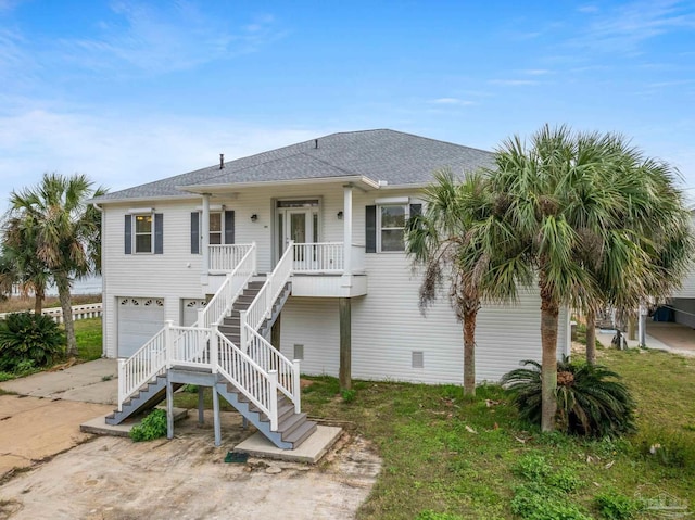 view of front of home featuring covered porch and a garage