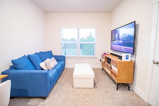 living room with light carpet and baseboards