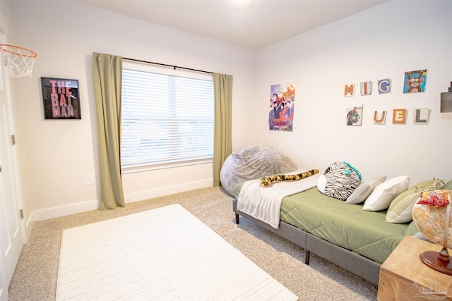 carpeted bedroom featuring baseboards