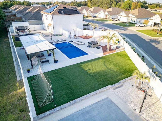 view of swimming pool featuring a fenced backyard, a residential view, and a patio area