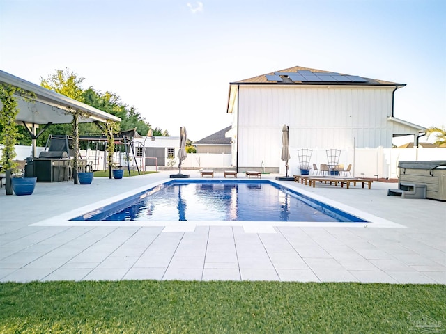 view of pool featuring a fenced backyard, a fenced in pool, a hot tub, and a patio area