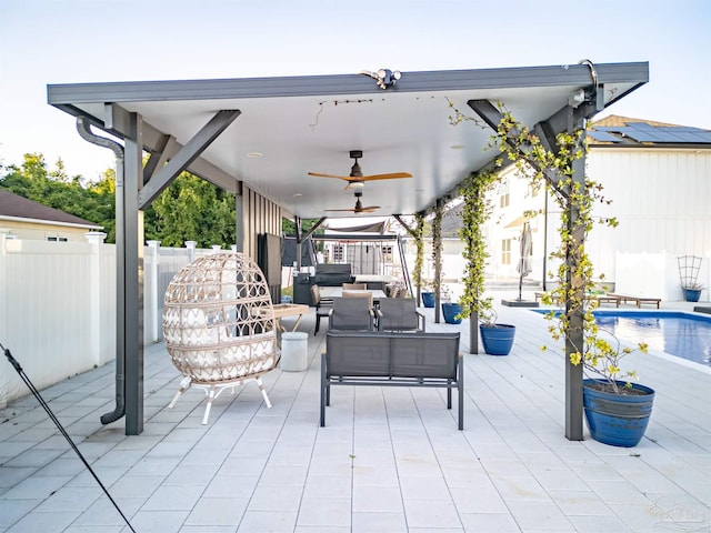 view of patio featuring a fenced in pool, an outdoor living space, fence, and a ceiling fan