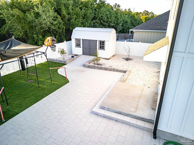exterior space with a shed, a fenced backyard, and an outdoor structure
