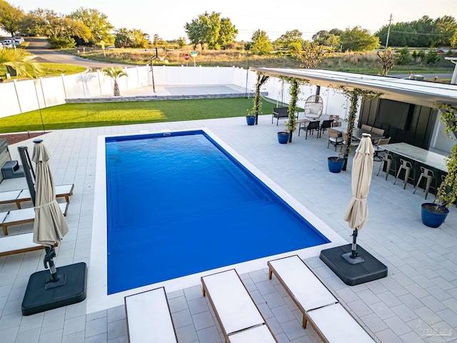 view of pool featuring a patio area, a fenced backyard, outdoor dining space, and a fenced in pool