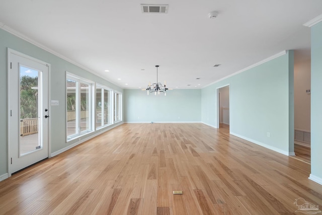 unfurnished living room featuring ornamental molding, a chandelier, and light hardwood / wood-style flooring