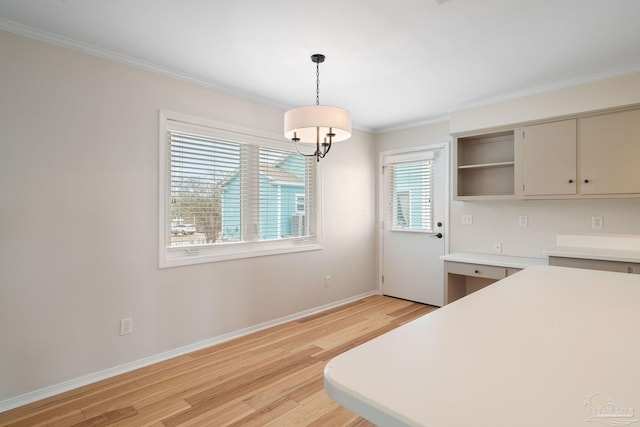 unfurnished bedroom featuring built in desk, light hardwood / wood-style flooring, and ornamental molding