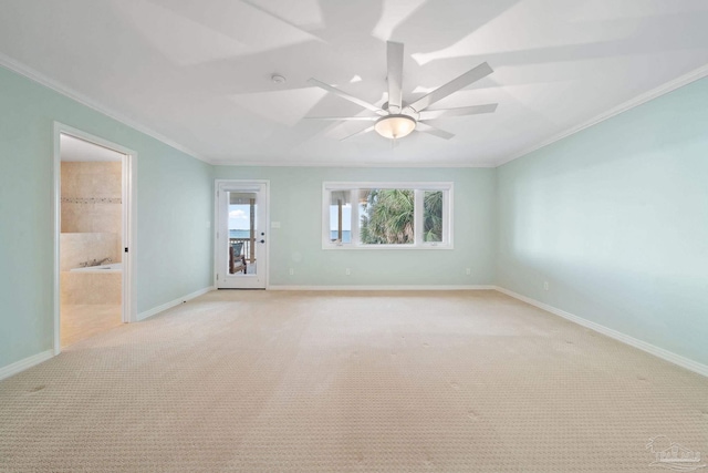 carpeted empty room featuring crown molding and ceiling fan