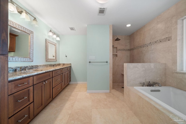 bathroom with vanity, tile patterned floors, and plus walk in shower