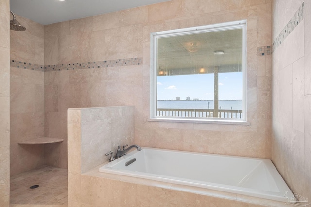 bathroom with a water view and shower with separate bathtub