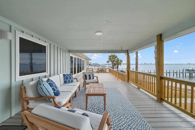 wooden terrace with outdoor lounge area and a water view